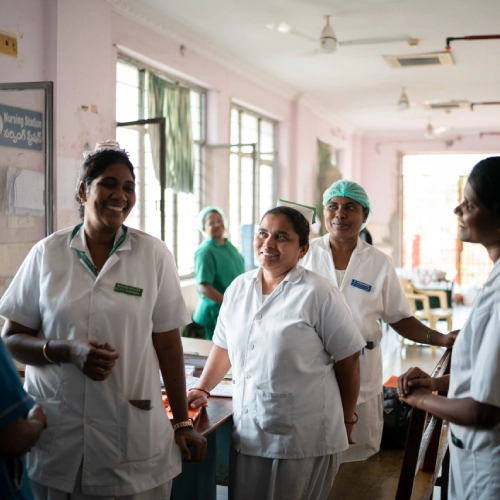 Doctor holding a patient's hands with reassurance